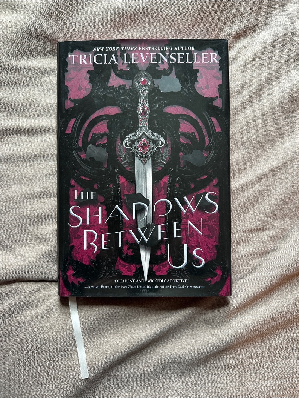 The Shadows Between Us by Tricia Levenseller - Dark Pink & Black Hardcover